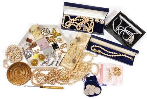 A large quantity of costume jewellery, to include mainly faux pearl necklaces and varying straps, clip on earrings, compacts and button hook, vintage necklace and earring set, etc. (1 box)