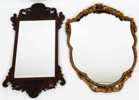 A 20thC flamed mahogany fret mirror, of shaped form with bevel glass, 75cm x 43cm and a further gilt framed mirror. (2)