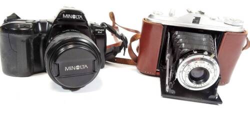 A Minolta camera, with power zoom 35:80mm 1:4 (22)-5.6 49mm AF lens, the camera 9cm H and a Isolette camera in brown leather case.