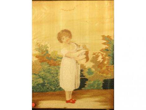 A Georgian silk and woolwork picture of a young girl in a verre eglomise and gilt frame