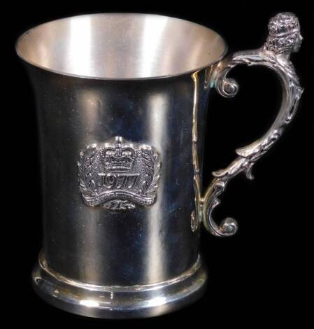 A Elizabeth II Silver Jubilee mug, with elaborate figure handles and cylindrical body raised with 1977 plaque, on circular foot, Birmingham 1977, 10cm H, 9½oz. (boxed)