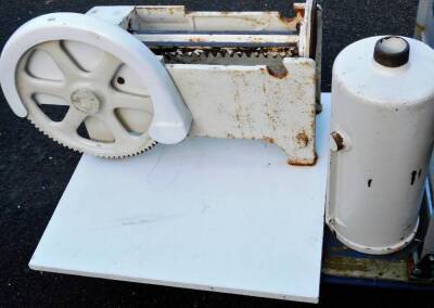 An industrial meat slicer, painted white, on wooden plinth base, 40cm H.