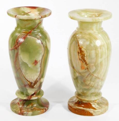 A pair of green onyx vases, each of shouldered circular form with compressed rims, on circular feet, typically decorated with a swirl pattern, 24cm H.