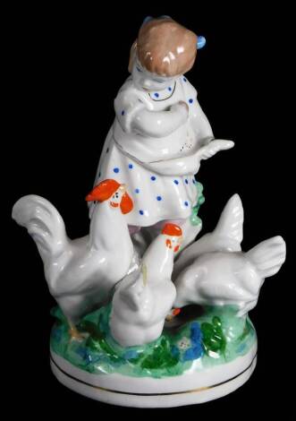 A Russian Dulevo porcelain group of a young girl, feeding chickens, in green, white and orange, 17cm H.