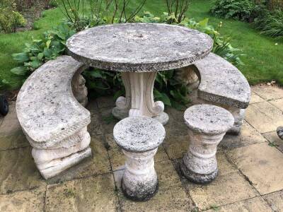 A matched garden suite, comprising two garden curved benches, with lion and ball feet, two inverted garden seats, and a circular table on inverted scroll stem and platform base, 48cm high (5)