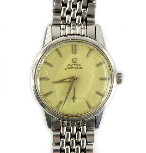 A 1960 Omega Seamaster gentleman's wristwatch, in steel case with champagne coloured dial and rectangular batons, the back decorated with a sea horse seamaster logo, with Omega strap, sold with original guarantee from model number 17044044, purchased in B