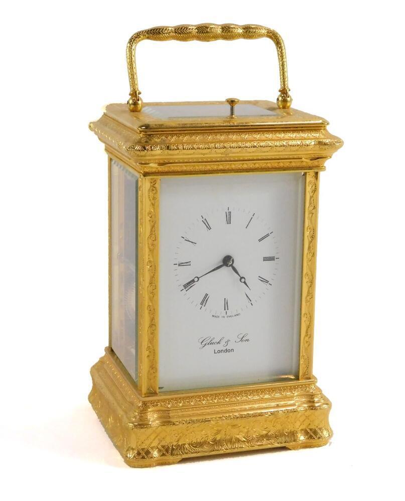 A carriage clock by Gluck & Son of London, in gilt brass case with