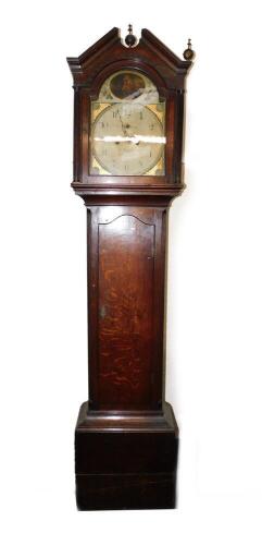 Brumhead (J N O) Stamford. A Georgian oak longcase clock, the break arch dial painted with an oval framed allegorical figure, flowers and gilt spandrels, circular dial bearing Arabic numerals, subsidiary seconds dial, two train eight day movement with bel