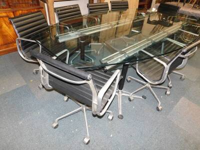 A set of nine ICF Cadsana desk chairs designed by Charles Eames, upholstered in black ribbed leather, and raised on an aluminium swivel base, together with a matched boardroom table, possibly ICF, the elliptical glass top raised on four black cylindrical - 3