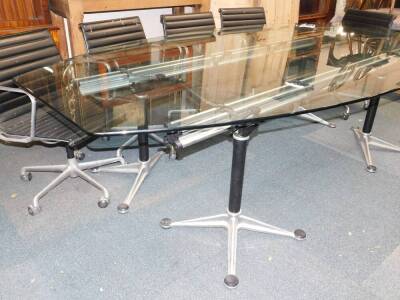 A set of nine ICF Cadsana desk chairs designed by Charles Eames, upholstered in black ribbed leather, and raised on an aluminium swivel base, together with a matched boardroom table, possibly ICF, the elliptical glass top raised on four black cylindrical - 4