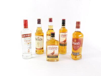 A bottle of Grant's Triple Wood Blended Scotch Whisky, Bell's Highland Earl and Famous Grouse Scotch Whisky, further smaller bottle of Famous Grouse Scotch Whisky, and a bottle of Smirnoff Vodka Recipe 21. (6)