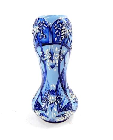 A Moorcroft pottery vase, of squat waisted form, tube lined with stylised flower heads and tendrils, in blue glazes, and with implied encrustation, by Emma Bossons, signed and dated 2008, painted and impressed marks, 15.5cm H.