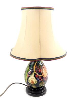 A Moorcroft pottery ovoid lamp decorated in the Queens Choice pattern, with lamp shade, 22cm H. 