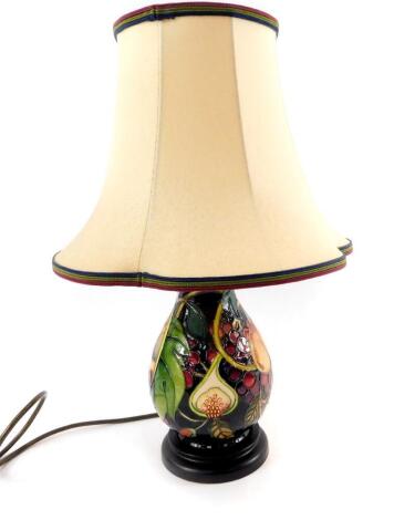 A Moorcroft pottery ovoid lamp decorated in the Queens Choice pattern, with lamp shade, 22cm H.