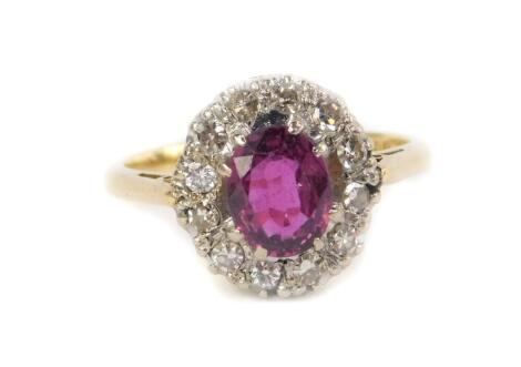 An 18ct gold ruby and diamond ring, in an oval setting, size G, 3.0g.