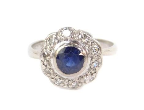 A platinum sapphire and diamond ring, in a flower head setting, size L, 3.7g.