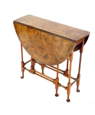 An early 20thC figured walnut spider leg occasional table, with crossbanded fall flap top and pad feet, 70cm W.