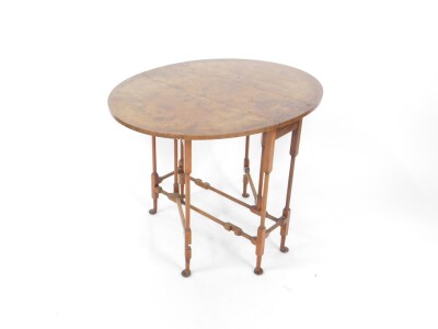 An early 20thC figured walnut spider leg occasional table, with crossbanded fall flap top and pad feet, 70cm W. - 2