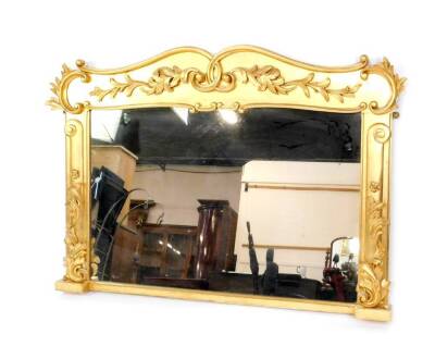 A Victorian gilt overmantel mirror, with C and S shaped scrolling rococo frame, with foliate applique mouldings, 92cm H, 130cm W.