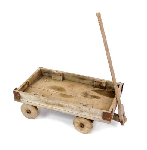 A vintage wooden pull-a-long trolley, 80cm W, 46cm D.