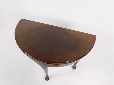 A George III mahogany demi lune tea table, with a fold over top, raised on turned legs and pad feet, 75cm W. - 3