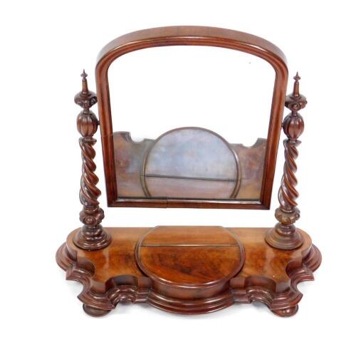 A Victorian flame mahogany dressing table mirror, with arched plate, twist columns, lift flap and shaped base, 75cm H, 72cm W.