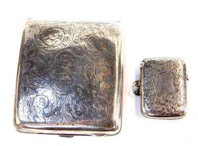 A George V silver cigarette case, of curved and hinged design, engraved with foliate scroll decoration and with a monogram 'AHI', Birmingham 1916, 3.98oz, together with a Victorian silver vesta case, with engraved decoration on a blank cartouche, Birmingh