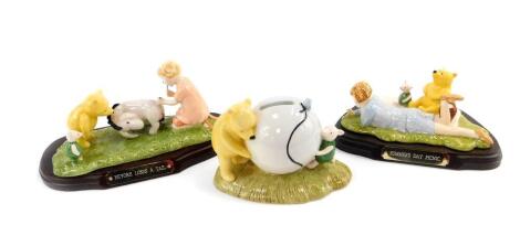 Two Royal Doulton Winnie-The-Pooh Collection figure group, Eeyore Looses a Tail, and Summer's Day Picnic, both limited edition of 5000, with plinths, and boxes, together with a Royal Doulton Winnie-The-Pooh Collection Pooh's Blue Balloon money ball (AF). 