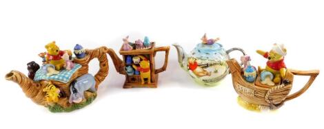 Four Disney Showcase Winnie-The-Pooh pottery teapots, with original boxes.