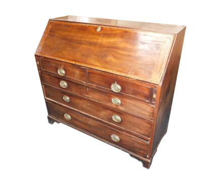 A George III mahogany rosewood and cross banded bureau,the fall flap opening to reveal a central door flanked by semi secret compartments, drawers and recesses, over two short and three long graduated drawers, raised on bracket feet, 110.5cm H, 122cm W, 5