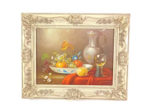 Arthur Munding (German b.1922). Still life of fruit, flagon and a half filled wine glass, oil on canvas, signed, 28.5cm x 38.5cm.