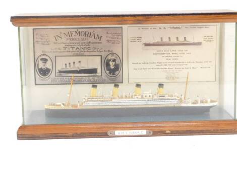 A scale model of the SS Titanic, in a wooden and perspex case, case 32cm W. We have received instructions from the vendor to sell without reserve.