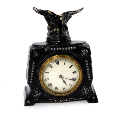 A late 19thC Continental black painted metal mantel clock, circular white enamel dial bearing Roman numerals, clockwork movement, the case with eagle surmount, 18.5cm W.