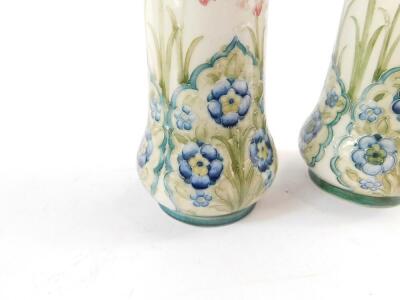 A pair of early 20thC Moorcroft Macintyre pottery vases, of cylindrical form, decorated with wild orchids and forget-me-nots, printed and painted marks, made for J W Baker, Aberdeen, 24.5cm H. - 3