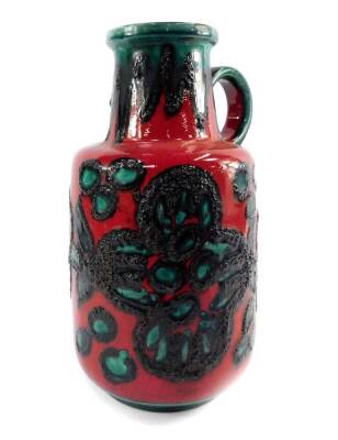 A late 20thC West German fat lava floor vase, with a handle, decorated with stylised flowers against a red ground, shape no 408-40, 39cm H.