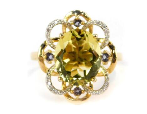 A modern design floral cluster ring, with central oval cut peridot, with four tiny diamond set petals and four round brilliant cut amethysts on a yellow metal band, stamped 14K, size Q 1/2, 5.9g all in.