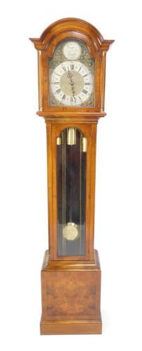 A 20thC walnut cased long case clock, the break arch dial with circular Tempus Fugit plaque, silvered chapter ring bearing Roman and Arabic numerals and S T. Mich. Whitt. cherub and dolphin spandrels, three train eight day movement, with Westminster chime