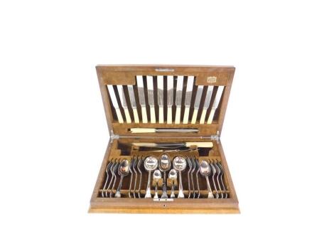 A silver plated canteen of cutlery, decorated in the Old English pattern, in an oak and walnut case, with presentation plaque, engraved 'Presented to Inspector W S Covell, As A Token Of Esteem By The Peterborough City Police, On The Occasion Of His Retire