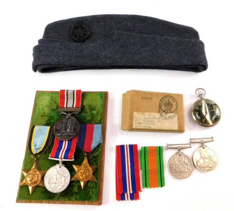 A WWII RAF Air Crew medal group, possibly to A J Scarr, comprising Air Crew Europe Star, 1939-45 Star and 1939-45 War Medal, together with a British Fire Services Association Medal awarded to A J Scarr, an RAF cap, further 1939-45 Medal and a Defence Meda