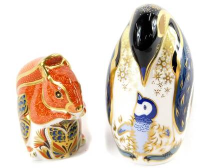 A Royal Crown Derby Imari paperweight, modelled as a penguin and chick, and another modelled as a red squirrel, both boxed. (2)