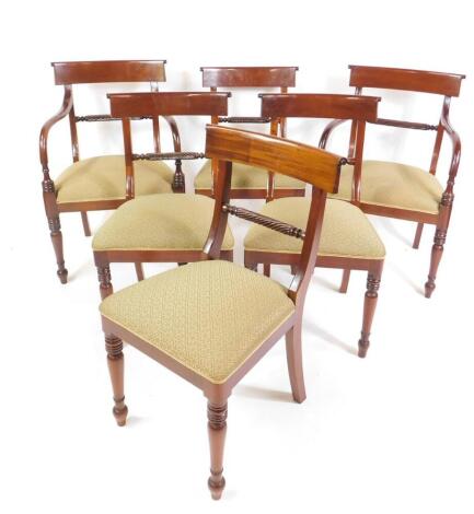 A set of six reproduction mahogany Regency style dining chairs, with rope twist horizontal rails, with over upholstered seats, on turned supports, comprising two carvers and four single chairs.