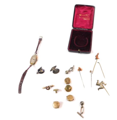 An early 19thC lady's 9ct gold cased wristwatch, on a leather strap, horse shoe bar brooch, coral set tie pins, a pair of silver and niello cuff links, and sundries. (qty)