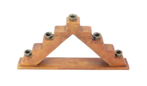 A pine and brass candle holder, of stepped form, raised on a rectangular base, 49.5cm W.