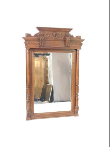 A late 19thC French Empire style mahogany overmantel mirror, carved with acanthus and scrolling leaves, inset rectangular bevelled glass, flanked by fluted and turned columns, 147cm H, 99cm W.