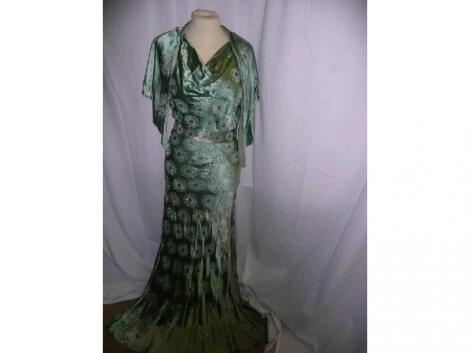 A green satin vintage evening dress with matching belt and small cape