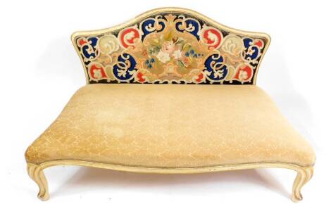 A Victorian cream painted and parcel gilt serpentine day bed, with tapestry back, over stuffed seat, raised on cabriole legs, 153cm W.