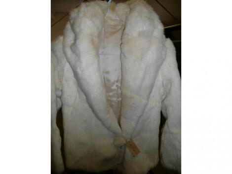 A cream fur jacket with large collar and satin lined