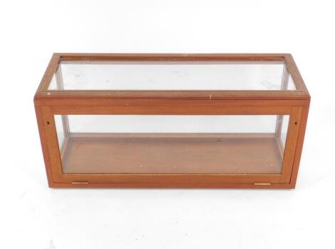 An early 20thC mahogany display case, with glazed sides and top, drop down front, 36cm H, 100cm W, 36cm D.