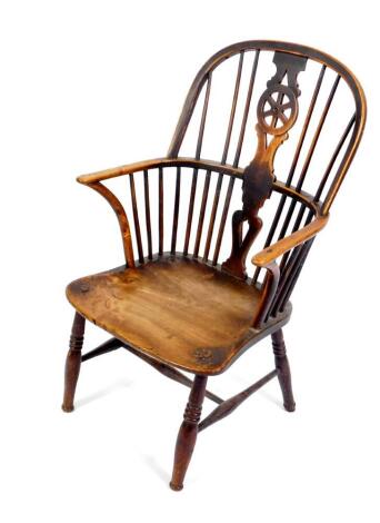 A 19thC oak and elm wheel back Windsor chair, with solid saddle seat, raised on turned legs united by an H frame stretcher.