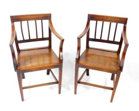 A pair of George III East Anglian oak and elm carver chairs, c1800-1820, with fluted backs, and solid seats, raised on square tapering legs, united by stretchers.